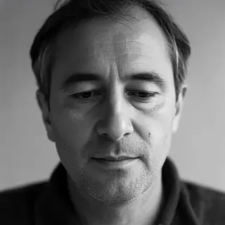 A portrait of a middle-aged man with a calm, serious express
