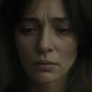 A face showing quiet melancholy — downcast eyes, slightly dr