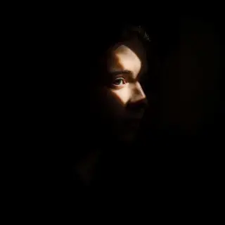 A portrait lit with classic Rembrandt lighting — triangle of