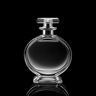 A clear glass perfume bottle on a reflective black surface w