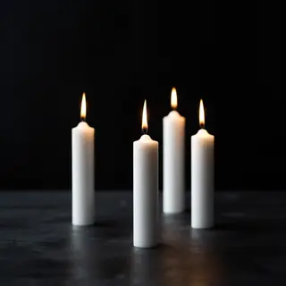 Exactly 4 white candles standing on a dark surface