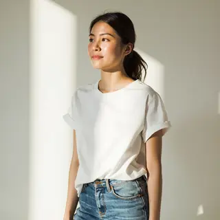 A woman standing upright in a relaxed pose, arms at her side