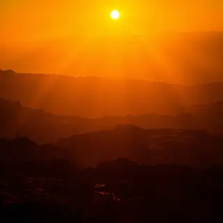 A landscape photograph bathed in golden hour light — long wa