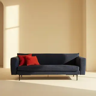 A minimalist room with walls in #F5E6CC (warm cream), a sofa