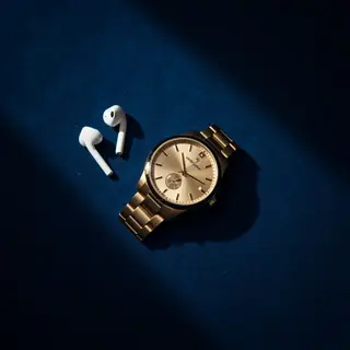 A product flat-lay on a #1A1A2E (deep dark blue) background,