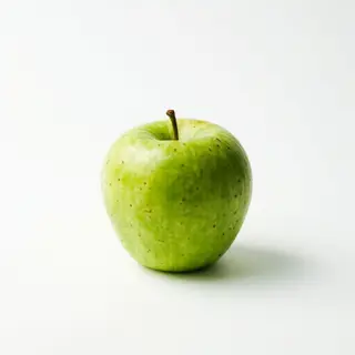 A ripe green apple on a seamless white background with soft 