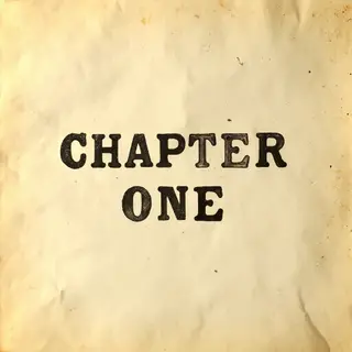The word 'CHAPTER ONE' typed on aged paper with a vintage ty