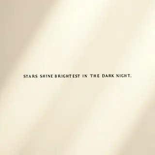 'Stars shine brightest in the dark night' displayed on a cle