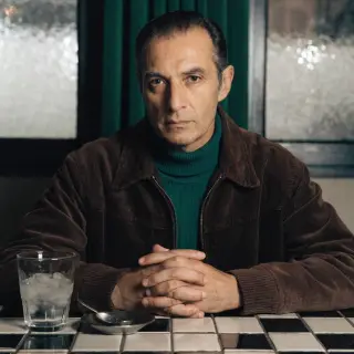 A portrait of a middle-aged man with a calm, serious express