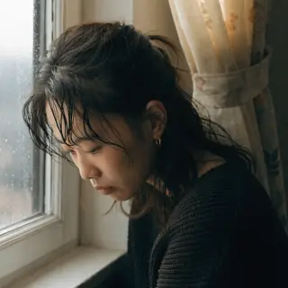 A face showing quiet melancholy — downcast eyes, slightly dr