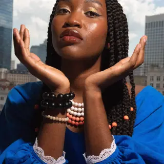A woman holding her hands out in front of her palms-up, all 