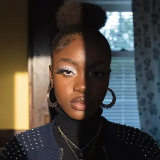 A portrait with dramatic split lighting — half the face brig