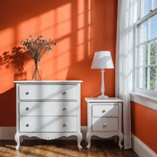 A bedroom wall painted in #FF6B35 (burnt orange) with white 