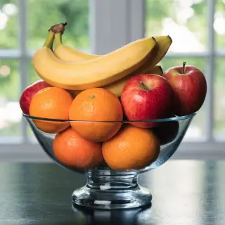 A fruit bowl containing exactly 3 bananas, 4 oranges, and 2 