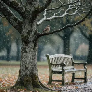 A bird perched on a branch, the branch extending from a tree