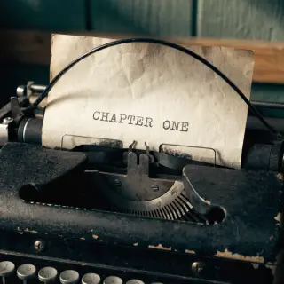 The word 'CHAPTER ONE' typed on aged paper with a vintage ty