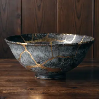 A Japanese kintsugi bowl — cracked ceramic repaired with vis