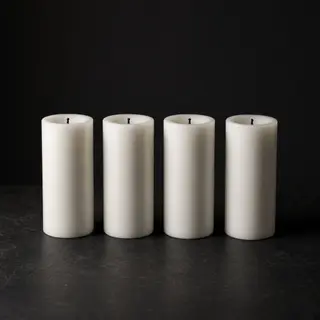 Exactly 4 white candles standing on a dark surface